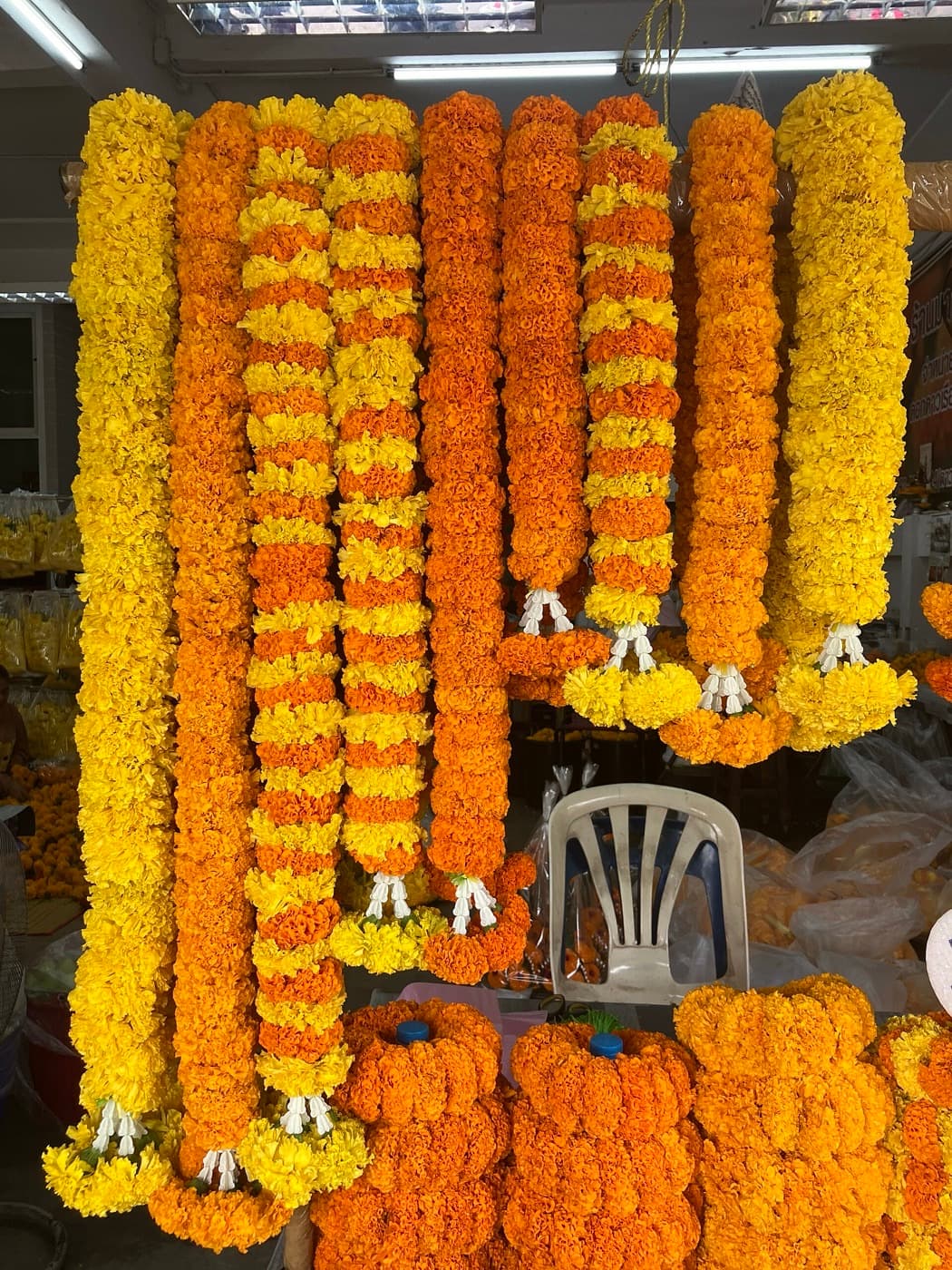 Marigold garlands strung up at a flower market
